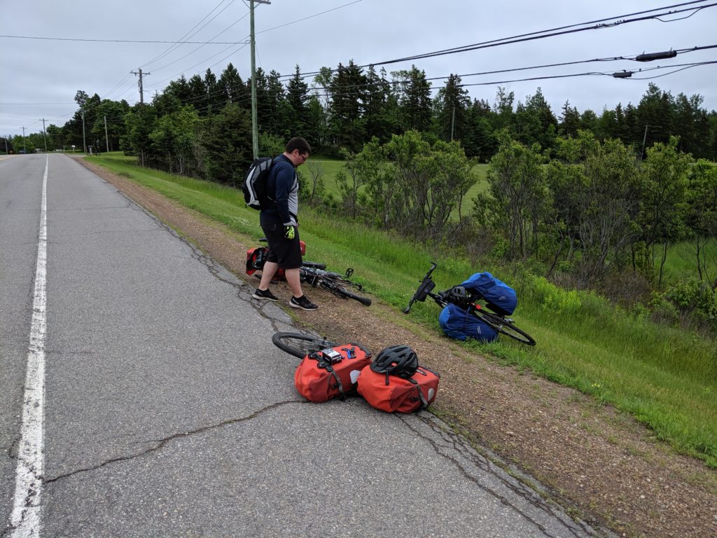 Fixing a flat at the side of highway.